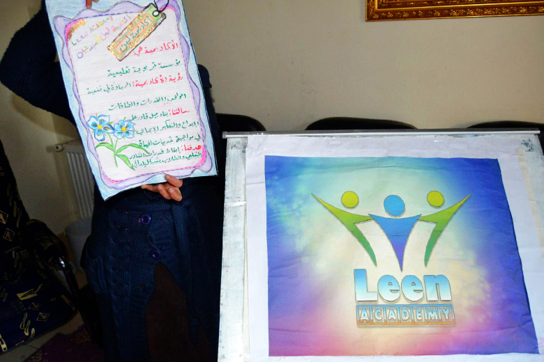 Shams showing the posters she has done in the institution. Moadamiyeh 2016. Photo: private